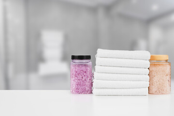 Various spa beauty threatment products and towels against blurred background