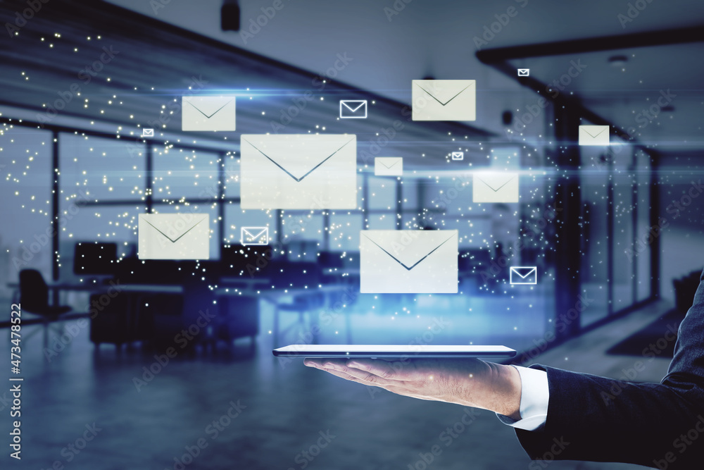 Poster close up of businessman hand holding pad with creative glowing letters interface on blurry office in