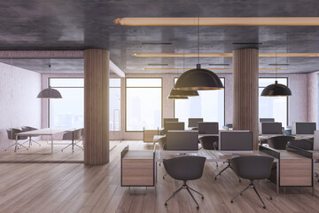 Minimalistic industrial coworking loft office interior with furniture, computer monitors, wooden, flooring and window with city view and daylight. Workplace and no people concept. 3D Rendering.