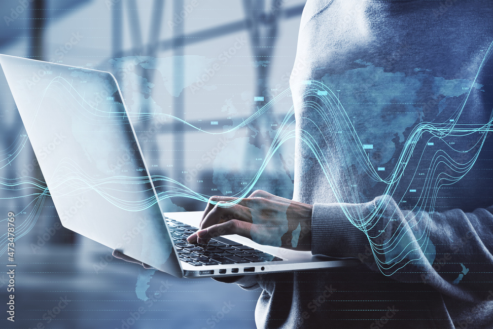 Poster Close up of hacker using laptop in blurry office interior with creative glowing business chart and map hologram on blurry background. Business data, hacking and market concept. Double exposure.
