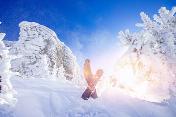 Snowboarder with snowboard background blue sky with sun light frozen rocks, Sheregesh ski resort....
