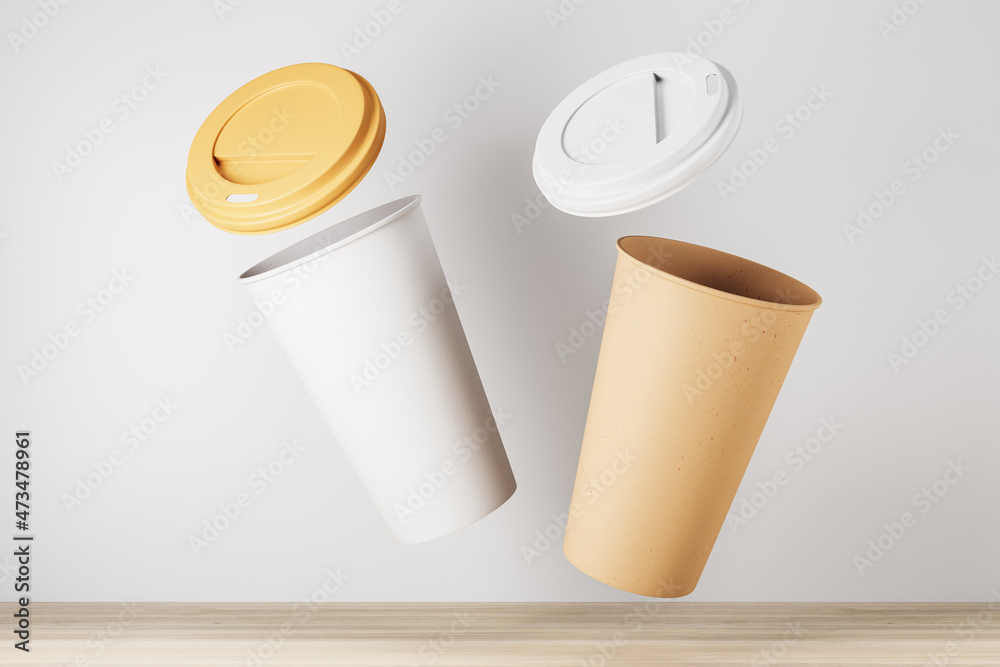 Aufkleber blank yellow take away coffee cup on white background and wooden surface. advertisement and mock up 