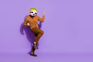 Full length portrait of weird unusual red panda mask person raise fists triumph isolated on violet...