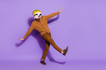 Fototapeta na wymiar Full body portrait of carefree weird mammal mask guy enjoy dancing clubbing isolated on violet color background