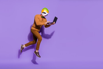 Full size profile photo of surreal mammal head person use wireless netbook isolated on purple color background