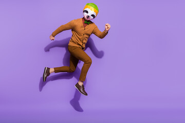 Full body profile photo of weird surreal red panda head guy running isolated on purple color background