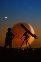Silhouette of a man, telescope and countryside under the starry skies with young Moon.