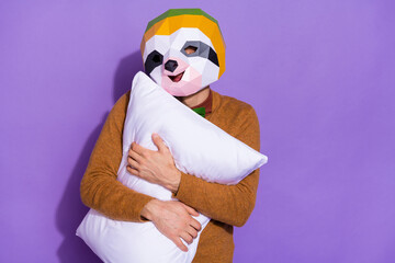 Photo of young guy good mood embrace pillow sleepy early red panda isolated over purple color...