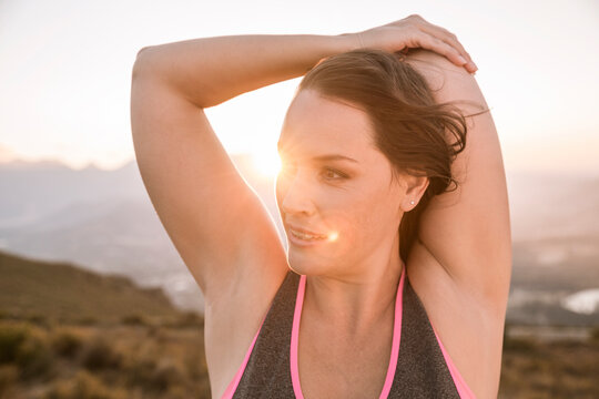 Portrait of Plus-Size-Model doing sports in the countryside at sunset