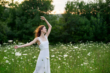 Woman in a white dress in a field on nature flowers freedom summer