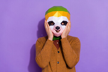 Photo of young man arms touch unusual face mask halloween event red panda isolated over violet color background © deagreez