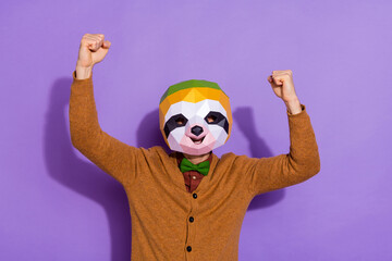 Photo of young man rejoice success fists hands triumph discount red panda isolated over violet color background © deagreez