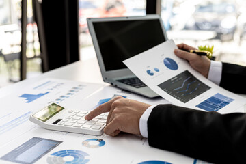 Business men are looking at the company's financial documents to analyze problems and find solutions before bringing the information to a meeting with a partner. Financial concept.