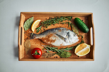 sea fish fresh ingredients lemon on wooden board