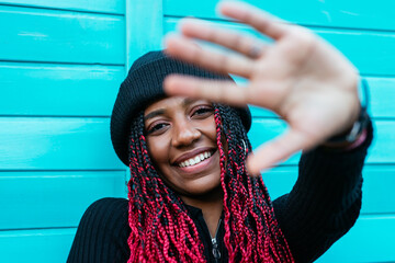 Glad ethnic woman showing stop gesture