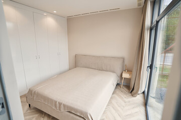 Modern light bedroom being with panoramic windows