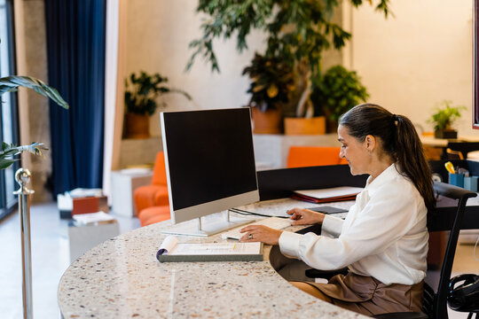 Cheerful woman working on computer