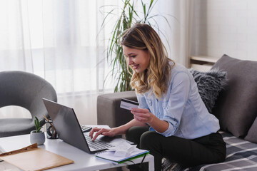 Woman making a payment with a credit card and laptop. Businesswoman working at home. Business,...