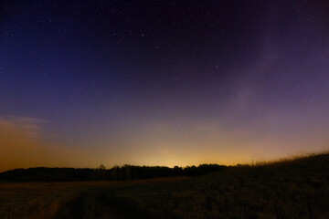 Fototapeta na wymiar Star night sky with light pollution from the city.