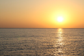 Fototapeta premium sun disc over blue sea