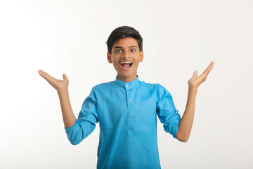 Indian boy in traditional wear and giving hand expression on white background.