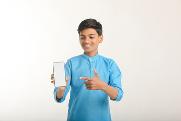 Indian little child in traditional wear and showing smartphone