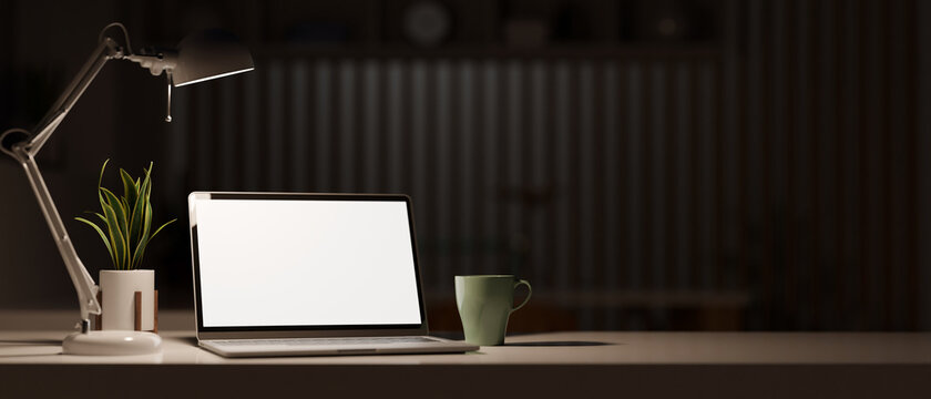 White screen laptop computer mockup in modern dark office room.