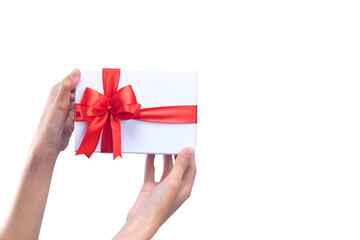 Hand holding white gift box with red ribbon
