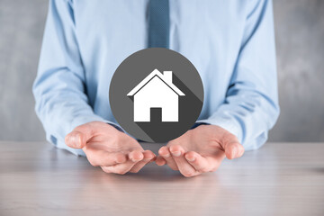 Real estate concept, businessman holding a house icon.House on Hand.Property insurance and security concept. Protecting gesture of man and symbol of house.flat icons with long shadows