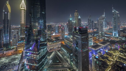 Fototapeta na wymiar Panorama of futuristic skyscrapers in financial district business center in Dubai night timelapse
