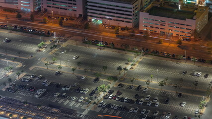 Big parking lot near mall crowded by many cars timelapse aerial view