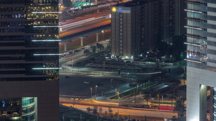Fototapeta na wymiar Busy Sheikh Zayed Road traffic aerial night timelapse in Dubai city, United Arab Emirates