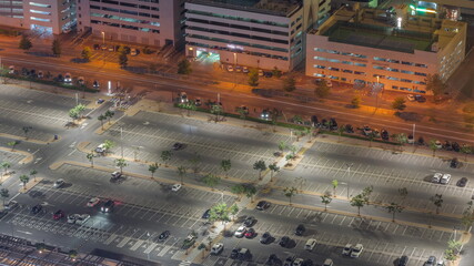 Big parking lot near mall crowded by many cars timelapse aerial view