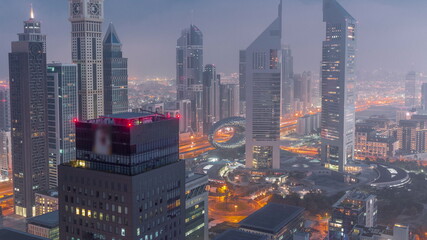 Skyscrapers on Sheikh Zayed Road and DIFC night to day timelapse in Dubai, UAE.