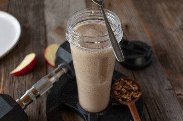 Fitness breakfast shake with whey protein, fruits and homemade granola for muscle building served...
