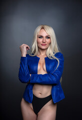 Fototapeta premium blonde, studio portrait of a young woman on a dark background