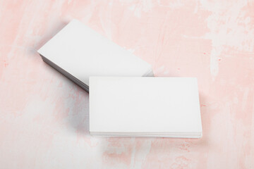 Blank business cards. Mock up on pink marble background. Copy space for text.