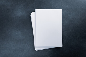 Blank flyer poster Blank flyer poster paper a4 or a5 isolated on black, place for your design mock up hollow blue tinted