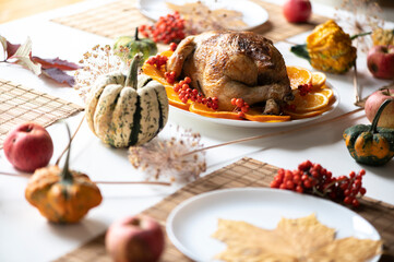 Thanksgiving celebration traditional dinner setting food concept. Top view on roasted turkey on a decorated table.