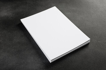 White business card sheet of paper a4 stack on a dark table. Clean portrait A4.