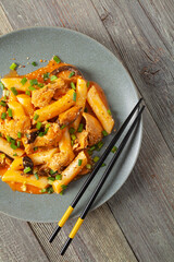 Traditional Korean Tteokbokki rice noodles with chicken, vegetables and shitake mushrooms. Prepared in a pan.