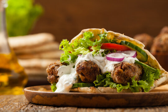 Kebab, kofta in pita, bun. Traditional southern European dish. Front view.