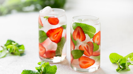 Refreshing drink with strawberries and mint in glasses