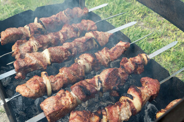 Marinated shashlik preparing on a barbecue grill over charcoal. Shashlik or Shish kebab popular in Eastern Europe. Shashlyk (skewered meat) was originally made of lamb. Roast Beef Kebabs On BBQ Grill.