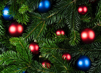 Fototapeta na wymiar Evergreen fir branches with christmas balls. Christmas background. Shot from above.
