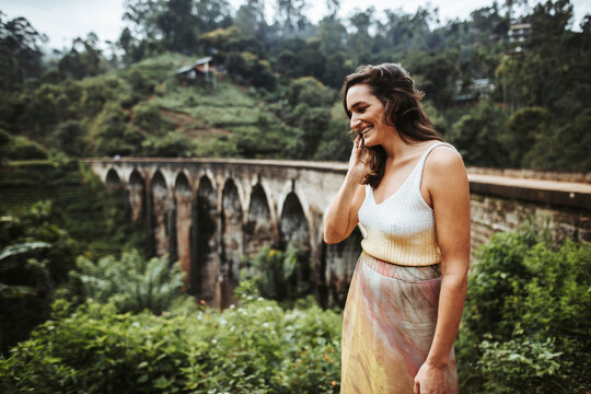 Sri Lanka, Uva Province, Demodara, Portrait of adult woman standing against Nine Arch Bridge
