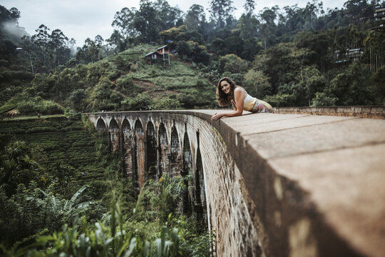 Sri Lanka, Uva Province, Demodara, Portrait of adult woman leaning on Nine Arch Bridge