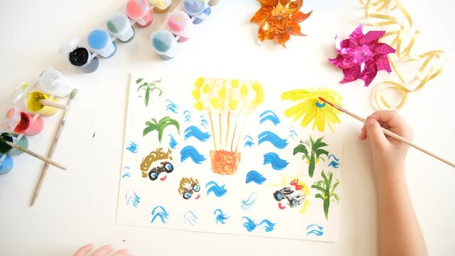 Child making card, painting hot air balloon, sea, tropical carden, sun... Inspiration for children. art children project. Travel holiday concept