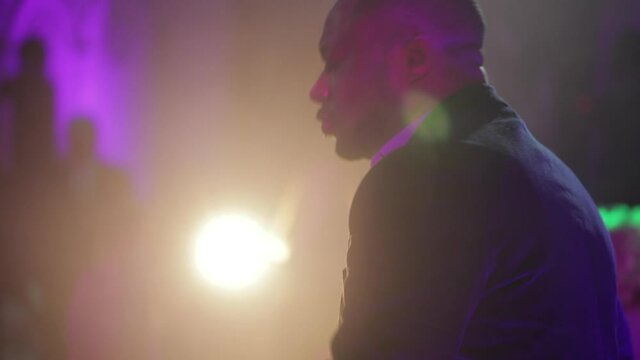 African American soloist on stage singing into microphone