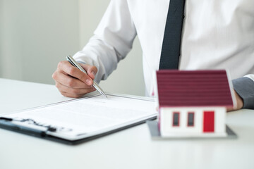 Agents working in real estate investment Hold the key home Ready home insurance signing contracts in accordance with the home buying insurance agreements approving purchases for clients